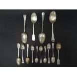 A collection of Georgian and later spoons, including three Georgian table spoons, one hallmarked