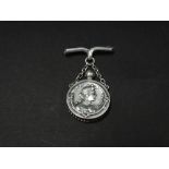 An attractive Art Nouveau silver pendant scent bottle on chain hanging on a bar brooch, each side of