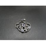 An attractive 925 silver amethyst, seed pearl and marcasite set openwork foliate scroll brooch,