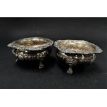 A Victorian silver pair of salts by Robert & Beik, with foliate cast rims and half fluted bodies and