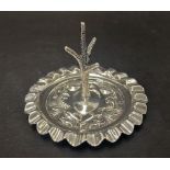 A George V silver ring tree with embossed shield decoration and wavy rim, maker James Dixon & Son,