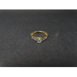 A contemporary 14ct. gold diamond set nine stone ring, the central claw set brilliant cut stone