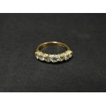 A contemporary 18ct. gold diamond set seven stone ring, the brilliant cut diamonds each of 0.10ct.