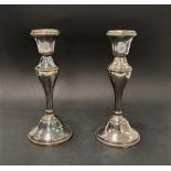 A pair of George V silver baluster candlesticks with weighted bases, indistinct maker's mark,