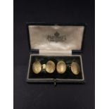 A pair of 18ct. gold heavy cufflinks, the oval panels with beaten decoration, stamped 18, within