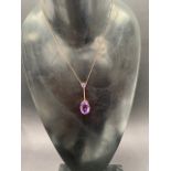 A 9ct. rose gold amethyst two stone pendant necklace, the large oval amethyst measures 11 x 7mm,