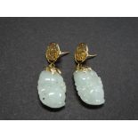 A pair of Chinese celadon jade 14ct. gold mounted drop earrings, the stud pierced with a coiling