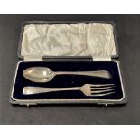 A George V boxed silver christening spoon and fork, maker W.H.H., Birmingham 1923, weight 1.90oz