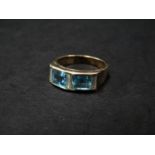 A modern 9ct. white gold (tested) diamond and aquamarine five stone ring, the square cut aquamarines