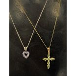 A 9ct. gold green sapphire and diamond chip set cross pendant necklace, the cross pendant length