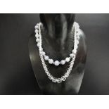 An Art Deco facet cut graduated glass bead necklace with white metal marcasite set clasp stamped