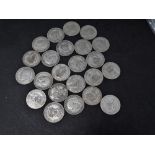 A collection of twenty three silver and .500 silver Edward VII-George VI one shilling coins,