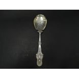 A good Victorian silver gilt serving spoon, the handle cast with a stylised peacock, the lobed