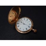 An 18ct. hallmarked gold full hunter crown wind pocket watch, the 32mm white enamel dial with