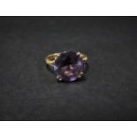 A 9ct. gold amethyst set cocktail ring, the amethyst measuring 13mm diameter, size Q, weight 4.6g
