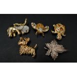 Five gilt metal costume jewellery brooches.