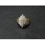 An 18ct. gold diamond set twenty nine stone diamond cluster ring, the plantinum claw set head of