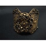 A gilt white metal filigree bangle, weight 69.8g approx.