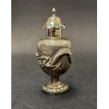 A Chinese white metal baluster pepperette, with screw lid over an ovoid body cast in relief with a