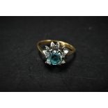 An 18ct. white and yellow gold aquamarine or topaz set ring, the stone of 0.50ct spread approx.,