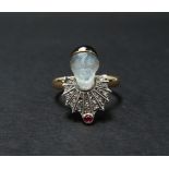 An unusual Victorian diamond ruby carved moonstone and black enamel mounted 9ct. gold ring