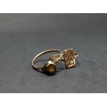 Two 9ct. gold rings, one set with a yellow stone, weight 2g approx.