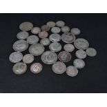 A collection of silver three pence, six pence and shilling coins, a mixture of silver and .500