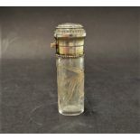 A 19th century continental white metal hinge lidded scent bottle, the glass with floral cut