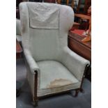 An Edwardian mahogany framed salon wing armchair (AF).