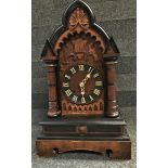 A 19th century pine cased Black Forest mantle clock with brass movement by J. Junghans, striking