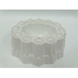 A white glazed pottery jelly mould by Shelley, width 19cm.