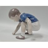 A Danish porcelain figure of a crouching boy by Bing & Grondahl, No.1636 EO, height 9cm.
