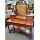 A late 19th century oak dressing table with swing mirror, trinket box and fitted with eight drawers,