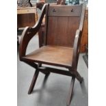 A 19th century oak Gothic style Glastonbury chair.