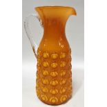 A retro orange opaque glass moulded jug, clear encased, height 26.5cm.