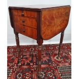 An early 19th century small mahogany and boxwood inlaid drop leaf writing table fitted with interior