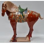 A 20th century Chinese Tang style large earthenware glazed horse, height 60cm, width 55cm.