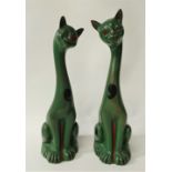 A pair of Aller Vale Torquay earthenware stylised models of cats with a glass winking eye with