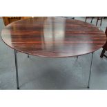 A mid 20th century Danish rosewood dining table by Fritz Hansen raised on four chrome metal legs,