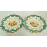 A pair of Davenport porcelain cabinet plates, the centre painted with river landscapes upon a mint