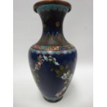 A Chinese cloisonne baluster vase decorated with chrysanthemum upon a blue ground and within