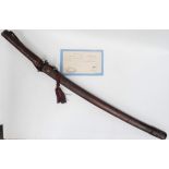 A WWII Japanese officer's sword katana with leather bound hilt and scabbard with pierced tsuba and
