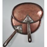 Two 19th century copper pot lids with steel handles, both with coronet and monogram MC, one oval,