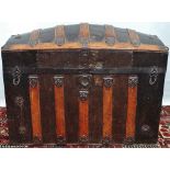 A late 19th century dome top metal and wood bound travelling trunk.