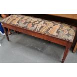 An Edwardian oak framed piano stool with an 18th century style woolwork seat.