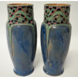 A pair of Royal Doulton stoneware vases with tubeline decoration upon a mottled blue ground, No.