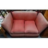 A 20th century Knole style two seater sofa with original wine coloured and faded upholstery.