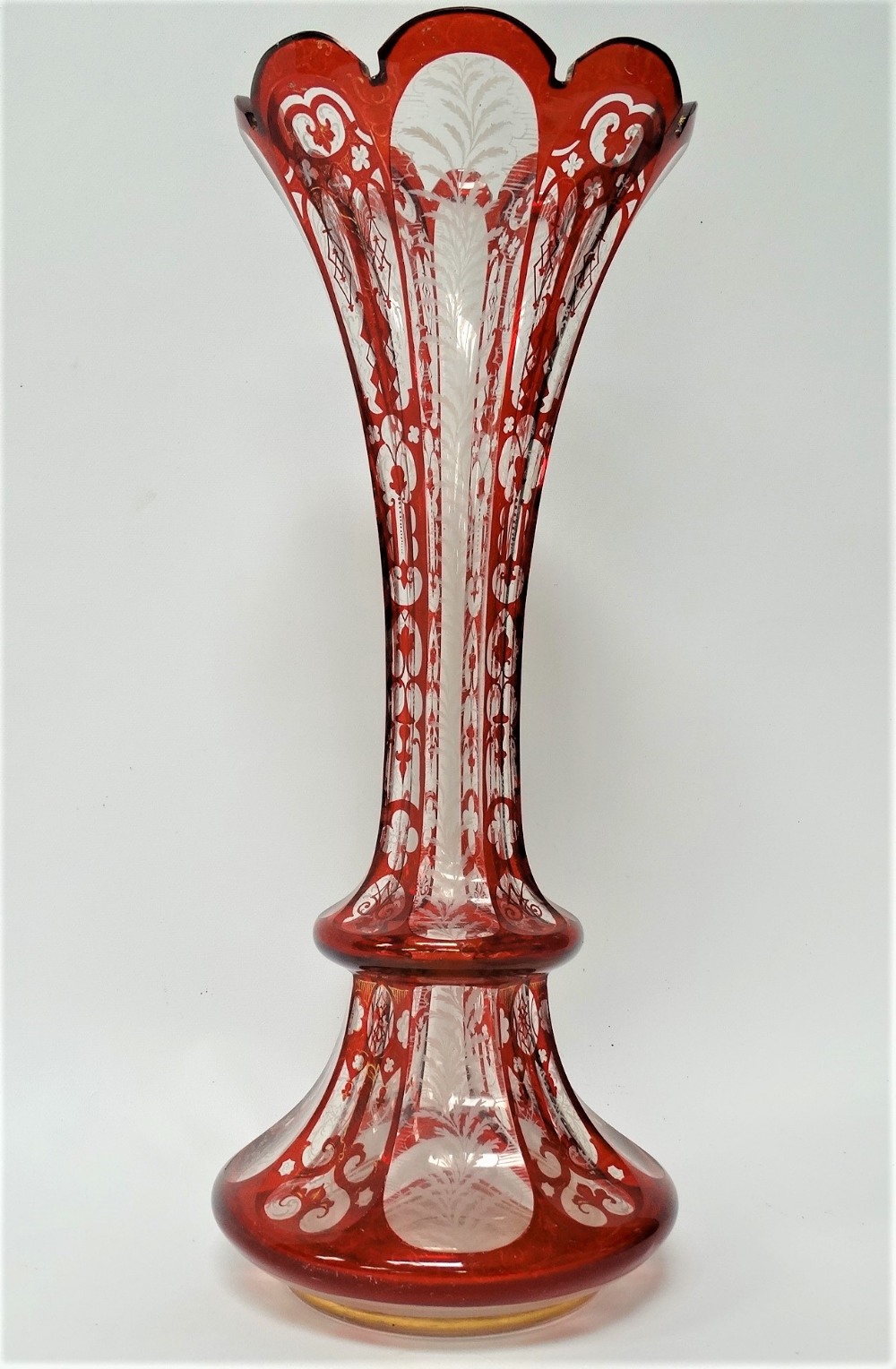 A Bohemian glass ruby overlay and white enamel and gilt painted flared vase, height 39.5cm (rim