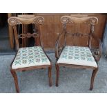 A set of four William IV mahogany dining chairs, including a carver and three single chairs.