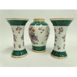 A Samson porcelain famille verte garniture comprising a miniature baluster vase and a pair of flared